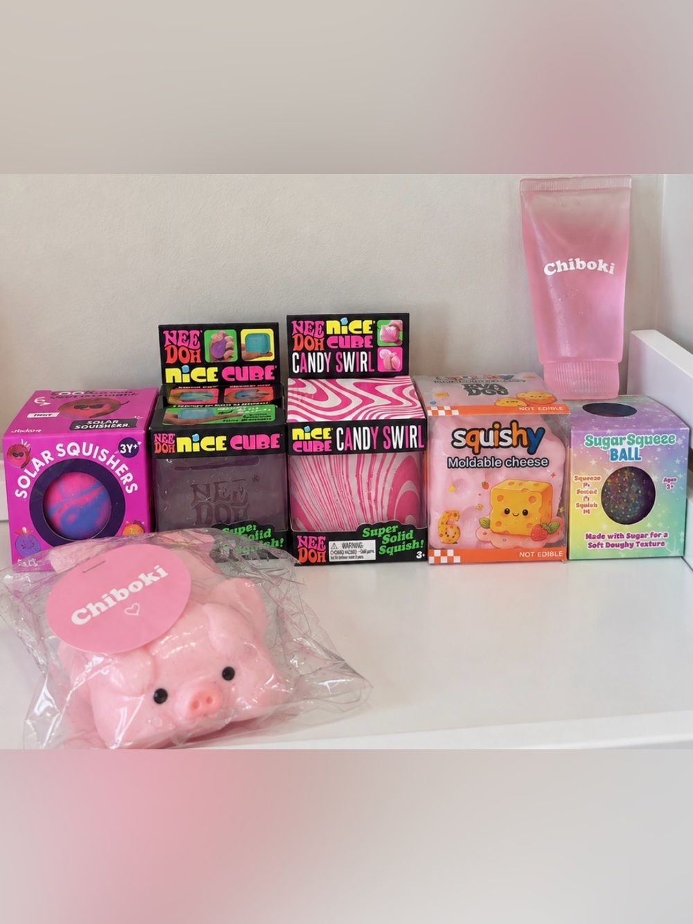 NeeDoh Candy Swirl Cube; Nice cube, Jadore Solar Squish, Moldable Pink Cheese&